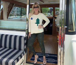 Erin wearing Maine flag sweater on a boat